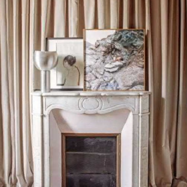 Wall divider curtains framing a fireplace